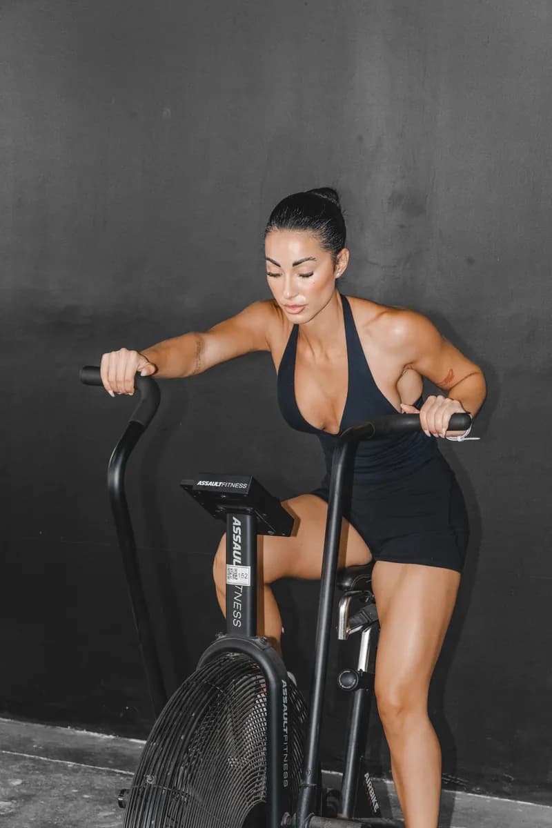 Jazmin driving through a sprint on an assault bike
