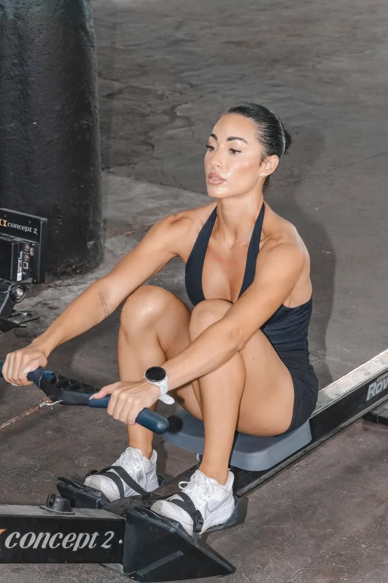 Jazmin mid-pull on a rowing machine
